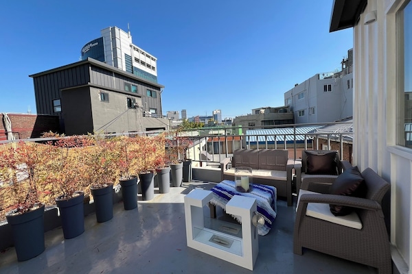 Urban rooftop escape — city views, cozy seating, and sunset vibe