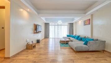 Deluxe Apartment | Living room | Flat-screen TV