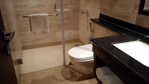 A bathroom with a toilet, a towel rack, and a sink. - I Towne (Deoghar)