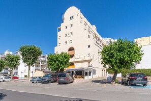 A multi-story building with a distinctive architectural design, including a rounded top and a central circular window.