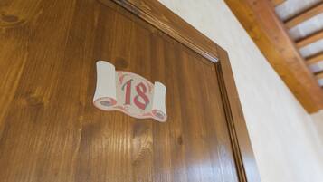 A wooden door with a number plaque.