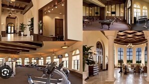Un hall d’hôtel doté d’une table de billard, d’appareils de musculation et d’un coin salon avec une cheminée.