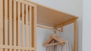 A wooden wardrobe with a hanging rack and a shelf. - Central & Stylish 1BD Flat - 8mins to Greenwich! (London)