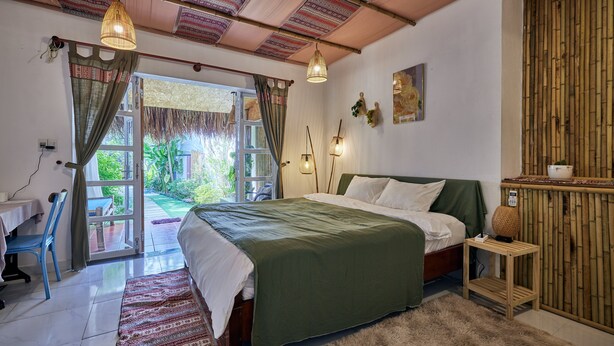 A bedroom with a bed, a desk, and a chair. - Unique Three bedroom with three Bathroom House in An Bang  (Thành phố Hội An)