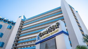 The Ocean Reef A Seaside Resort building facade with a modern design, featuring multiple balconies and a clear sky. - Amazing Views, Coastal  Paradise Experience! (Myrtle Beach)