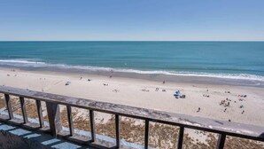 A beach with a clear view of the ocean and a railing in the foreground. - Amazing Views, Coastal  Paradise Experience! (Myrtle Beach)