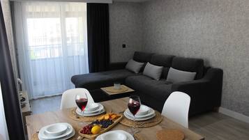 Senior Suite | Living area | 42-inch Smart TV with cable channels