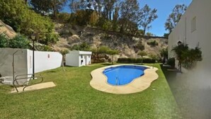 A backyard with a swimming pool, a small shed, and a grassy area. - Heart of Mojacar Playa with Beautiful " see view " and Sunshine (Ventanicas-el Cantal)