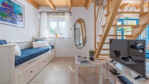 A cozy room with a bed, a desk with a computer, a TV, and a window with curtains. - Villa Sasso (Istria - Rajki) (Rajki)
