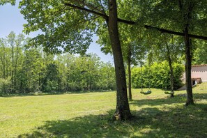 Enjoy a serene family getaway amidst lush greenery and a charming treehouse with a swing set.