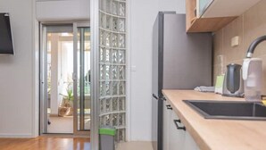 Una cocina moderna con refrigerador integrado, un lavamanos y una encimera.