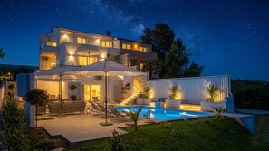A modern two-story house with a swimming pool, outdoor seating, and a covered patio area. - Villa Punat seafront villa by Wiibuk (Kvarner - Punat) (Punat)