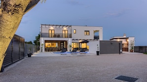 A modern two-story house with a covered patio, outdoor seating, and a swimming pool. - Villa LUKA (Istria - Loborika) (Loborika)