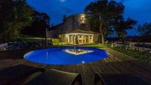 A swimming pool with lounge chairs, a house with a balcony, and a night sky. - Villa NEVIA (Istria - Ripenda Verbanci) (Ripenda Verbanci)