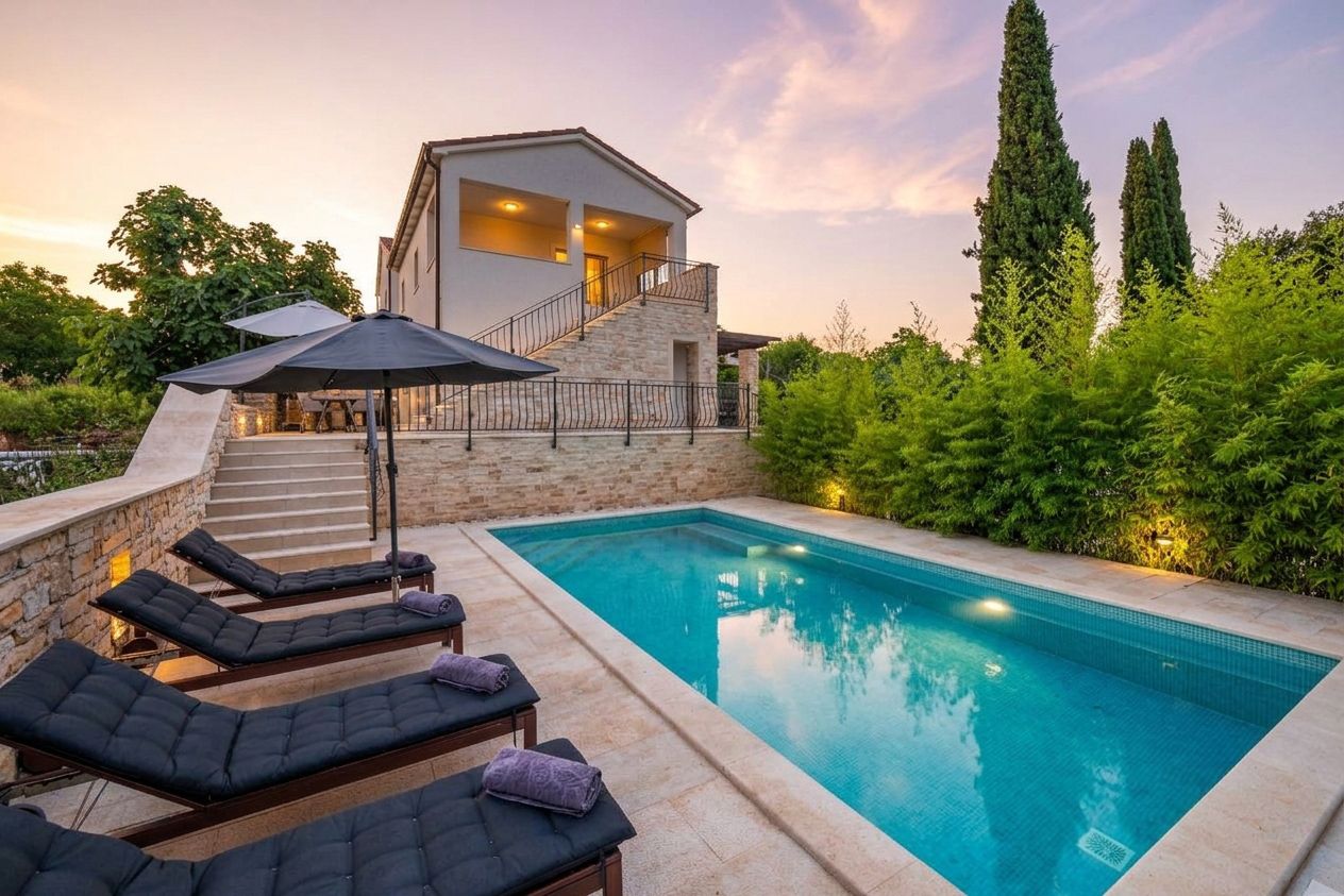 A modern house with a swimming pool, outdoor seating, and a staircase leading to the upper floor.