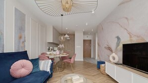 A modern living room with a sofa, dining table, and TV. - Elegant Apartment | Air Conditioning | Balcony | Workspace. (Wroclaw)