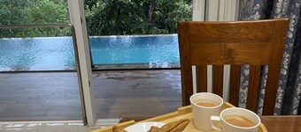 A 4 BHK VILLA WITH A PRIVATE INFINITY POOL SURROUDED BY SERENE HILLS