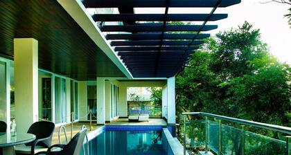 A 4 BHK VILLA WITH A PRIVATE INFINITY POOL SURROUDED BY  SERENE HILLS