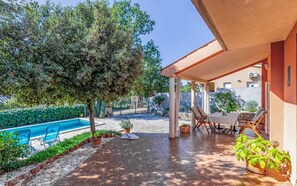 A covered patio area with a pool, outdoor seating, and potted plants. - Villa Ella Nature (Istria - Pula) (Pula)