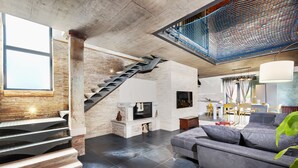 A modern living room with a staircase, a television, a sofa, and a dining area. - Villa Baraka in Rovinj for rent | WiiBuk (Rovinj)