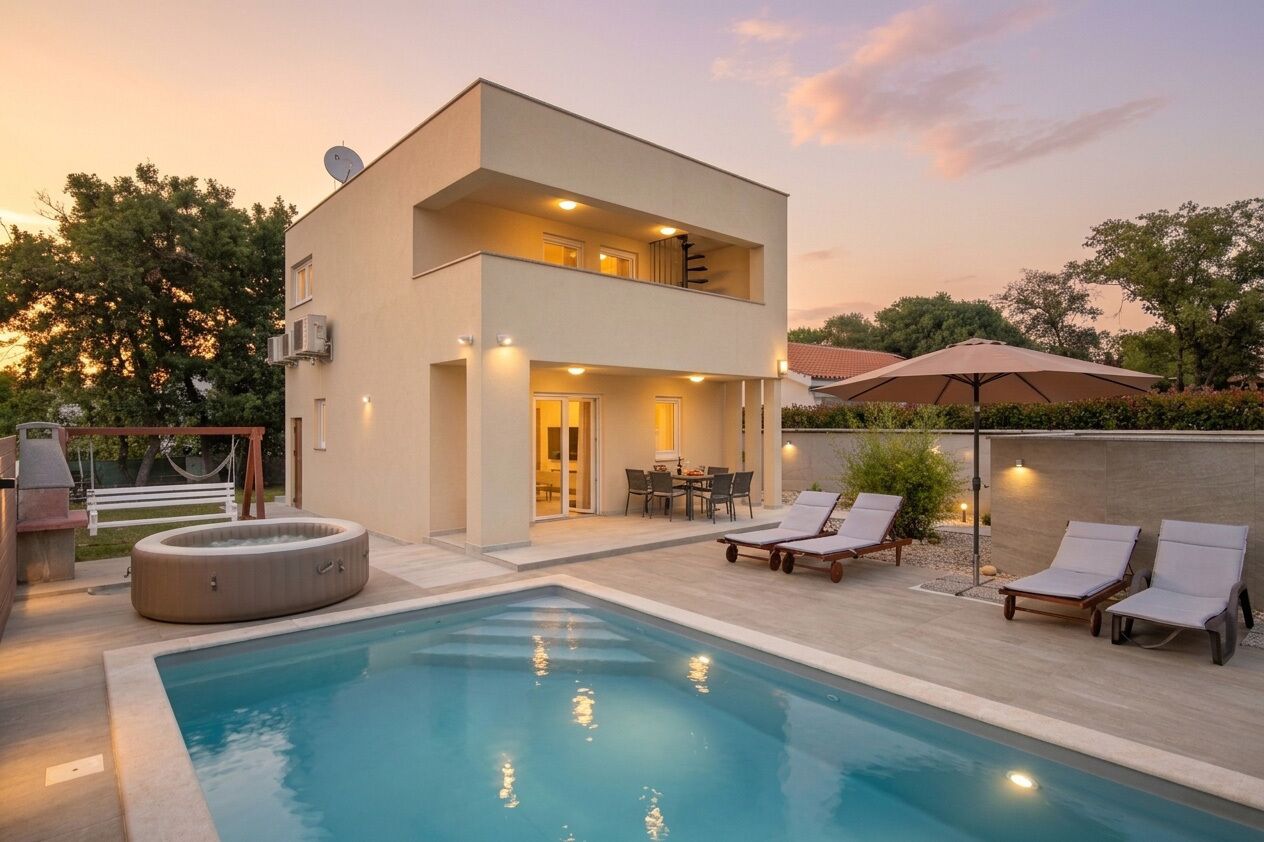 A modern two-story house with a swimming pool, outdoor seating, and a barbecue area.