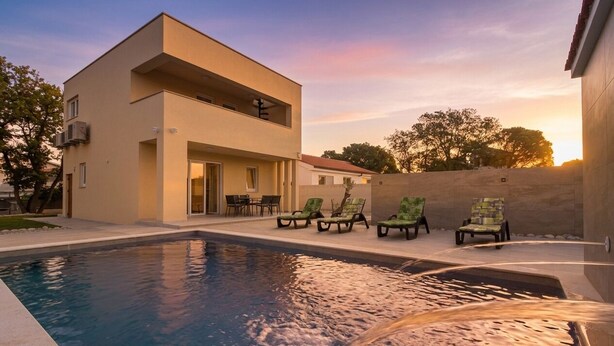 A modern building with a pool and outdoor seating. - Villa Sunshine (Istria - Peroj) (Peroj)