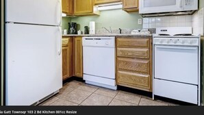 A kitchen with wooden cabinets, a white refrigerator, a dishwasher, a microwave, and a stove. - Gatlinburg Ski Week! 2 Bedroom 2 Bath Full Kitchen Sleeps N6834 (Gatlinburg)