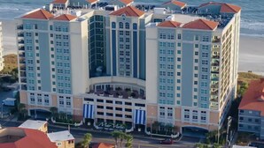 A multi-story hotel with a central atrium, balconies, and a marina view. - Mar Vista 1008 Direct Oceanfront in/outdoor pool (North Myrtle Beach)