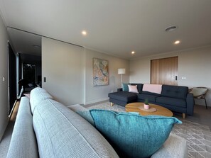 A modern living room with a sofa, a coffee table, and a couch.