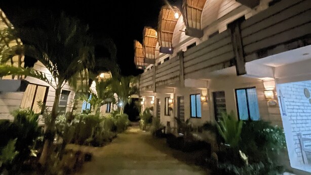 A nighttime view of a resort with multiple buildings, each featuring a distinctive dome-like structure on the roof. - Point F Siargao (General Luna)
