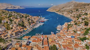 A coastal town with a marina, terraced houses, and a clear view of the sea. - 1st Floor Grey - Over The Sea Apartments with a sea view (Simi)