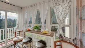 A sunlit room with a wooden table, two chairs, and a view of the outdoors. - 2 Mi to Hersheypark: Group Getaway w/ Deck (Hummelstown)