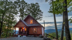 A cabin with a porch, a staircase, and a view of the mountains. - Majestic Views-Hot Tub - Views - Gas Firepit -4WD-AWD (Whittier)