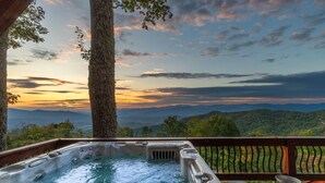 A hot tub on a wooden deck with a scenic mountain view at sunset. - Majestic Views-Hot Tub - Views - Gas Firepit -4WD-AWD (Whittier)