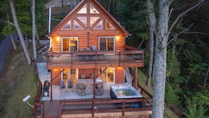 A two-story log cabin with a balcony, outdoor seating, and a hot tub. - Majestic Views-Hot Tub - Views - Gas Firepit -4WD-AWD (Whittier)