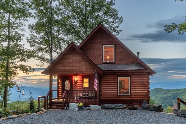 A rustic log cabin with a porch, a small deck, and a view of the mountains. - Majestic Views-Hot Tub - Views - Gas Firepit -4WD-AWD (Whittier)