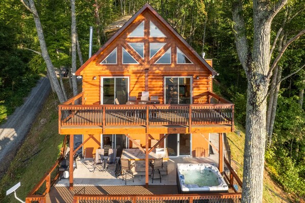 A wooden cabin with a balcony, a hot tub, and a deck. - Majestic Views-Hot Tub - Views - Gas Firepit -4WD-AWD (Whittier)