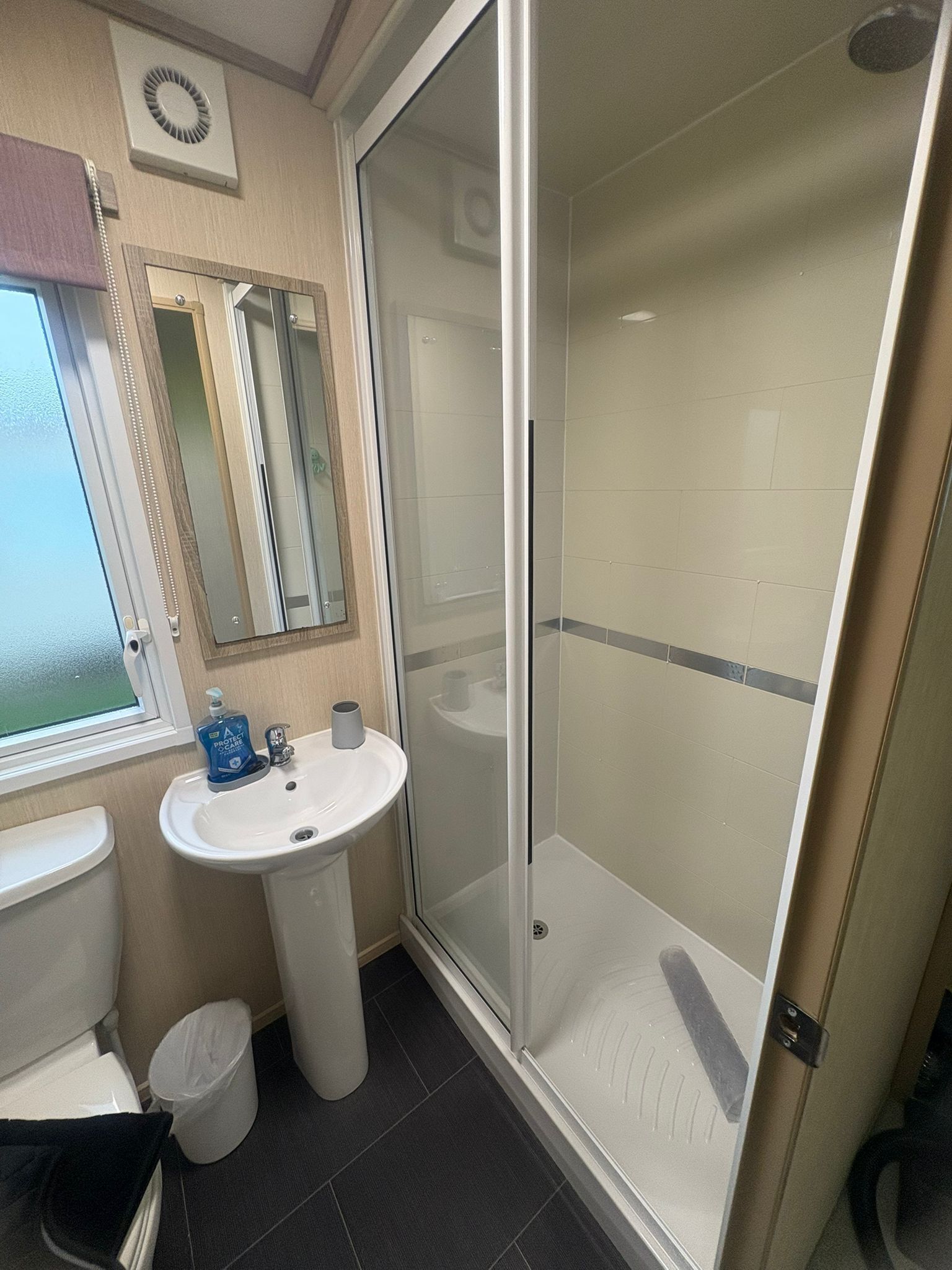 Shower, hair dryer, soap, toilet paper