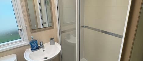 Shower, hair dryer, soap, toilet paper