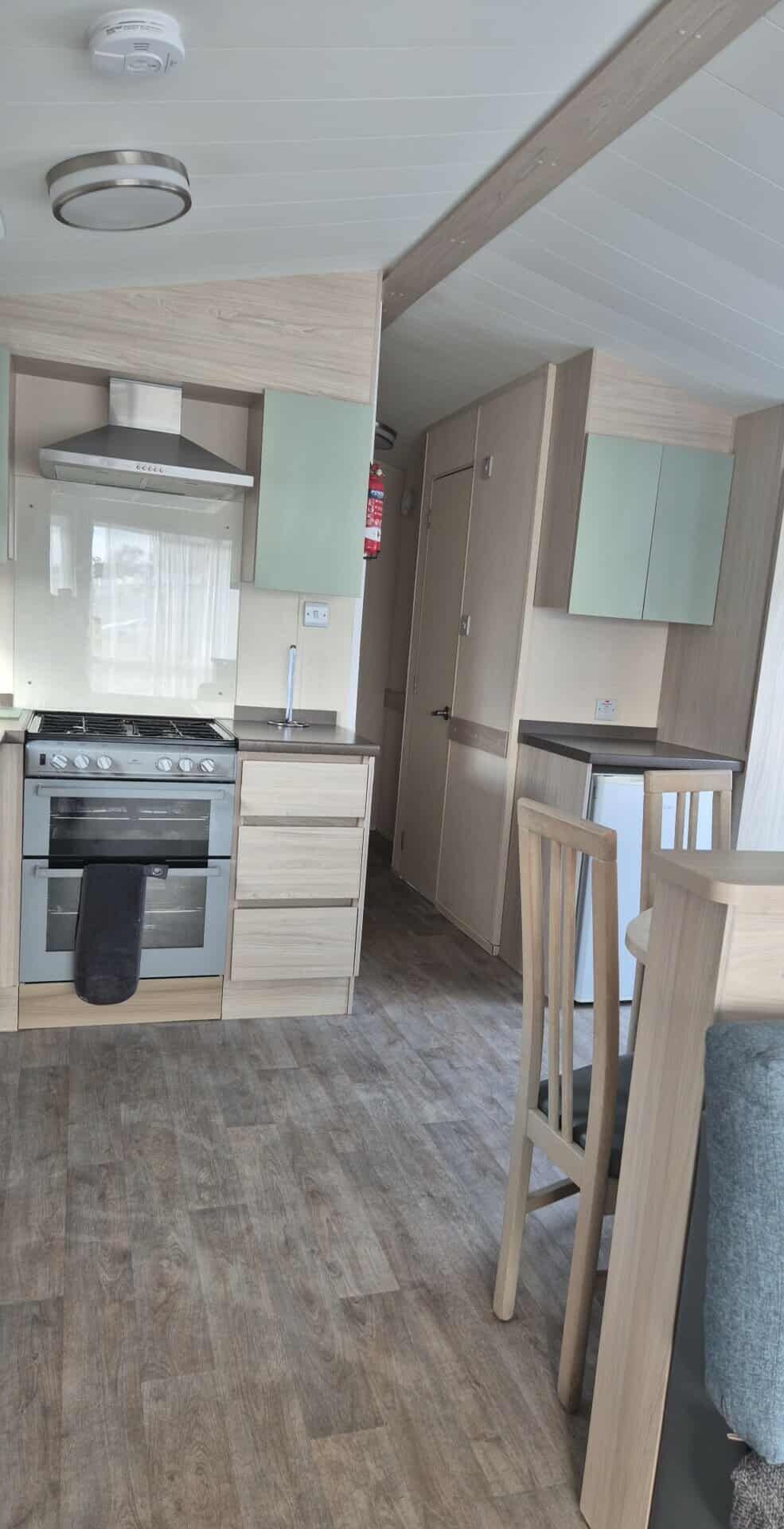 A compact kitchen with a stove, oven, and cabinets.
