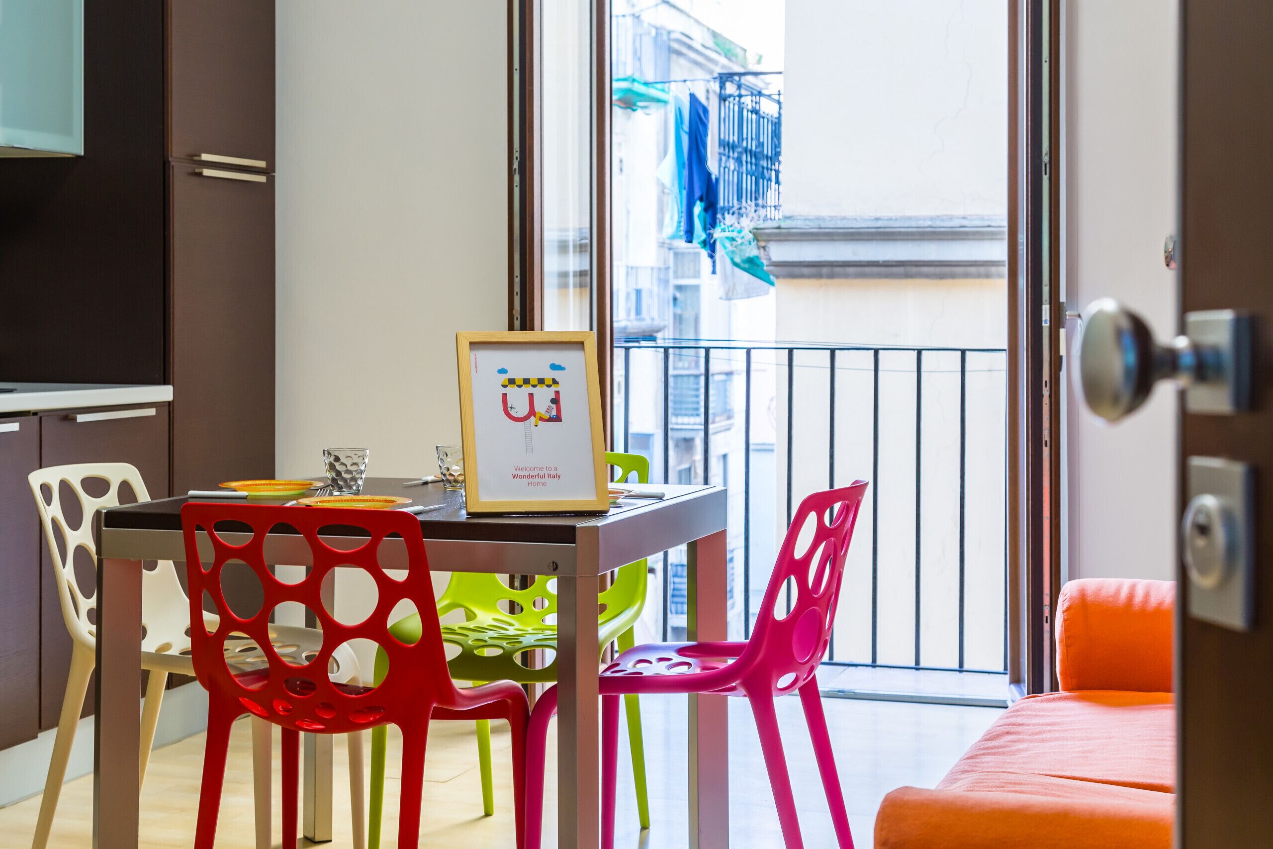 Una zona pranzo con tavolo, sedie e un quadro incorniciato.