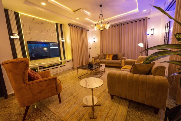 A modern living room with a sofa, armchair, and a coffee table.