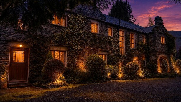 A stone building with multiple windows and a door, surrounded by greenery. - Daweswood, Patterdale luxurious, spacious home with walks from the door (Patterdale)