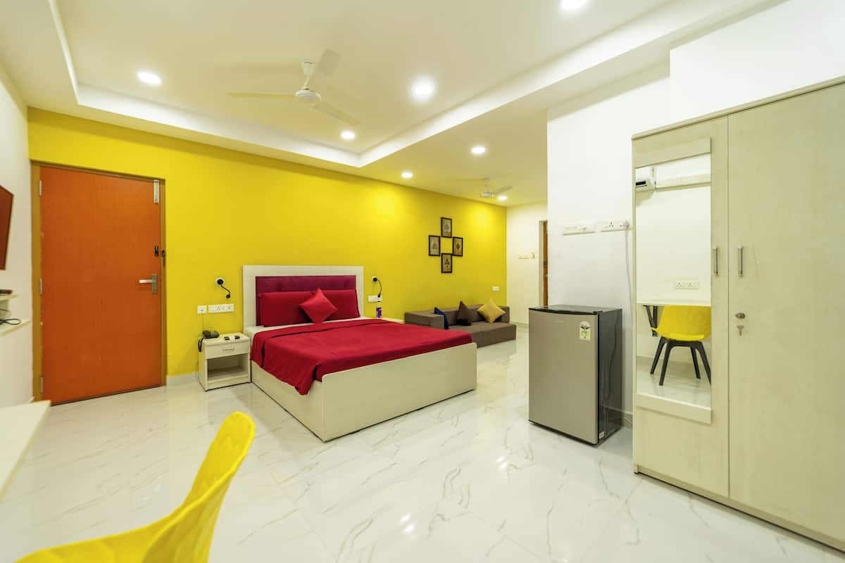 A modern bedroom with a bed, bedside tables, a wardrobe, a desk, and a chair.