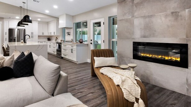 A modern living room with a fireplace, a sofa, and a coffee table. - Scottsdale Clubhouse | Pool, Spa & Golf Simulator (Scottsdale)
