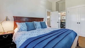 A bedroom with a bed, a nightstand, a lamp, and a wardrobe. - Casa Bella Estate in Wine Country w/ New Pool! (Kenwood)