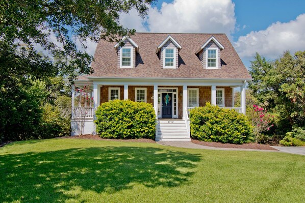 A two-story house with a front porch, a covered entryway, and a well-maintained lawn. - Carolina, Oceanside House in Emerald Isle, NC! (Emerald Isle)