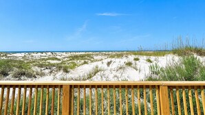 A beach with sand dunes and a wooden fence in the foreground. - Carousel, Oceanfront House in Emerald Isle, NC! (Emerald Isle)