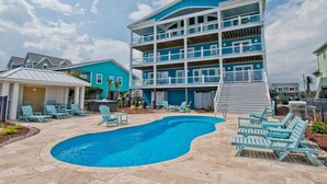 A multi-story building with a pool and outdoor seating area. - Compass Pointe, Oceanfront House in Emerald Isle, NC! (Emerald Isle)