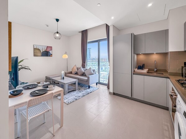 Elite Apartment | Living area | 50-inch Smart TV with cable channels - Luxury StayCation - Elegant Apartment With Balcony and Large Pool (Dubai)